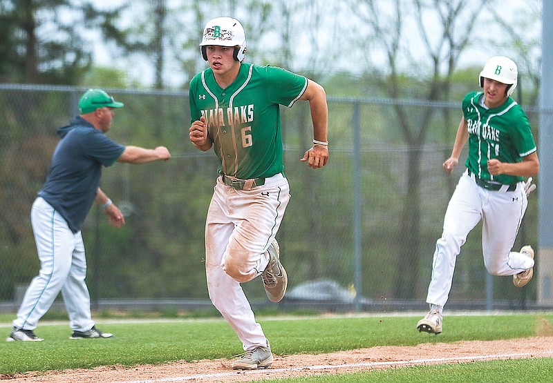 Blair Oaks baserunners Josh Isaacs (left) and Gavin Wekenborg race down the third-base line to score a pair of runs on a double by Lane Libbert during the fourth inning of Tuesday's game against Helias at the American Legion Post 5 Sports Complex.