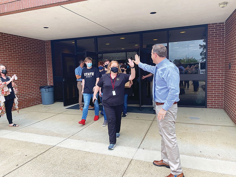 Principal Todd Marshall, right, joins Pleasant Grove High School faculty and students in a send-off for Theater Arts Director Debby Sutton and the school's theater company as they leave Tuesday for the state One Act Play competition in Schertz, Texas.  (Submitted photo by Shelby Akin)