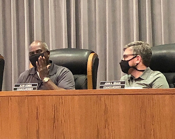 Ward 4 councilman Bob Washington, left, asks a question Tuesday while Ward 3 councilman Alan Combs listens during the Fulton City Council's meeting at Fulton City Hall.