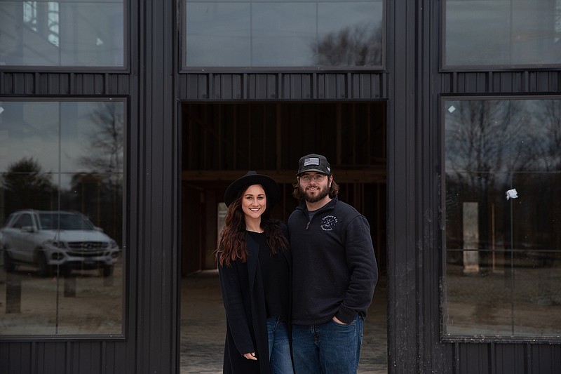 Owners Shelby and Caleb Stephens are pictured outside the main event space at Four Fifteen Estates near New Boston, Texas.
