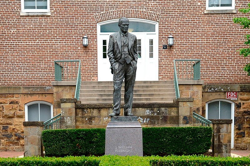 A statue of J. William Fulbright stands, Wednesday, July 1, 2020, near the west entrance of Old Main on the University of Arkansas campus in Fayetteville, Ark. A committee, comprised of students, faculty and staff members, and alumni, at the university has recommended to remove the statue of Fulbright, a former Senator who once voted against the interests of Black students and supported values antithetical to the university. (Andy Shupe/The Northwest Arkansas Democrat-Gazette via AP)