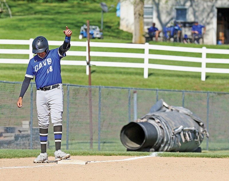 Capital City's Carlos Ayala celebrates hitting an RBI triple as fans look on from a nearby yard Thursday afternoon during a game against School of the Osage in Russellville.