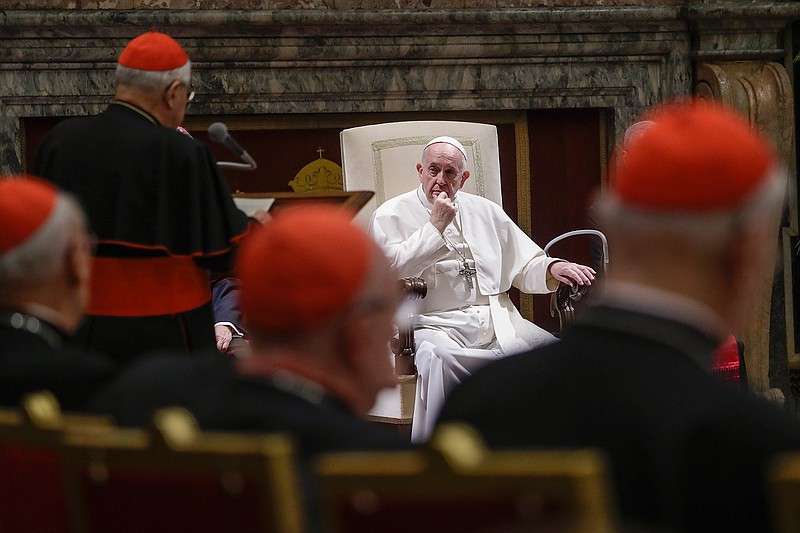 In this Dec. 21, 2019 file photo, Pope Francis listens to Cardinal Angelo Sodano, standing at left with back to camera, as he delivers his speech on the occasion of the pontiff's Christmas greetings to the Roman Curia, in the Clementine Hall at the Vatican. Pope Francis sent another chilling message to Vatican-based cardinals on Friday about his intent to hold them accountable for criminal misconduct, removing the legal obstacles that had prevented them from ever being prosecuted by the Vatican's criminal tribunal. (AP Photo/Andrew Medichini, Pool)