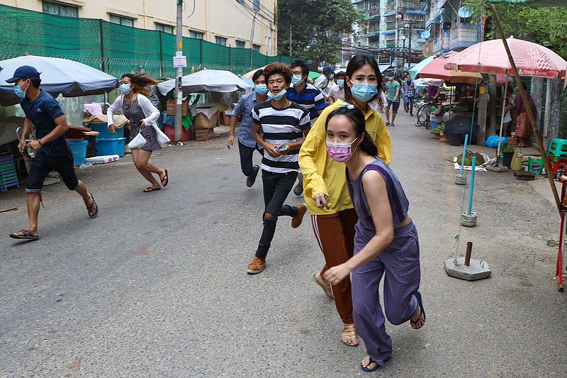 Anti-coup protesters run after seeing police and soldiers arrive to disperse their demonstration in Yangon, Myanmar, Tuesday, April 27, 2021. Demonstrations have continued in many parts of the country since Saturday's meeting of leaders from the Association of Southeast Asian Nations, as have arrests and beatings by security forces despite an apparent agreement by junta leader Senior Gen. Min Aung Hlaing to end the violence. (AP Photo)