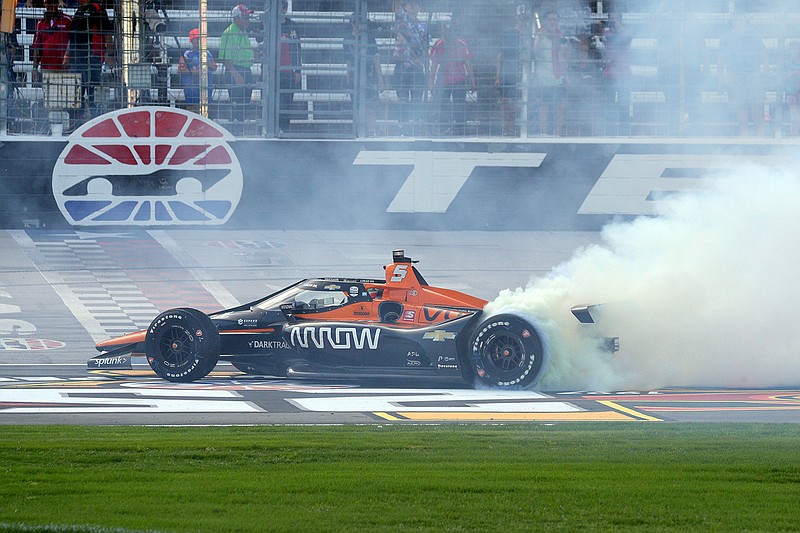 Pato O'Ward does a burnout on the track as he celebrates his victory at an IndyCar Series auto race at Texas Motor Speedway on Sunday, May 2, 2021, in Fort Worth, Texas. (AP Photo/Richard W. Rodriguez)