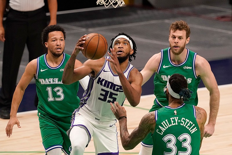 Sacramento Kings forward Marvin Bagley III (35) goes up for a shot between Dallas Mavericks' Jalen Brunson (13), Willie Cauley-Stein (33) and Nicolo Melli, right rear, in the second half of an NBA basketball game in Dallas, Sunday, May 2, 2021. (AP Photo/Tony Gutierrez)