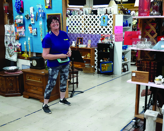 Yvonne Childs shows off some of the booths at A Little Bit of Everything, a local flea market. During the COVID shutdown, the thrift store operation relocated next to Big Lots from further down New Boston Road. 