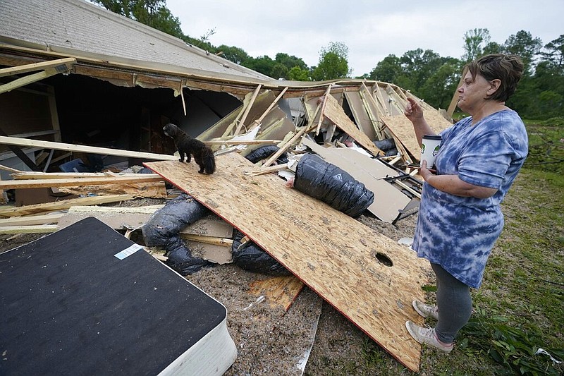 Vickie Savell looks at the remains of her new mobile home early Monday, May 3, 2021, in Yazoo County, Miss. Multiple tornadoes were reported across Mississippi on Sunday, causing some damage but no immediate word of injuries.