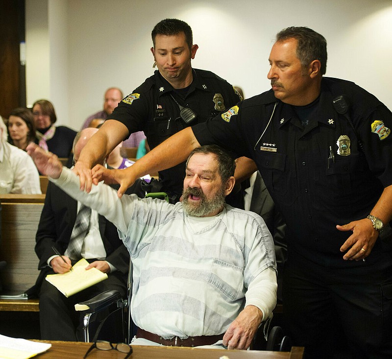 In this Nov. 10, 2015, file photo, Frazier Glenn Miller Jr., convicted of capital murder, attempted murder and other charges, gestures as Johnson County deputies remove Miller from the courtroom during the sentencing phase of his trial at the Johnson County District Court in Olathe, Kan. Miller, an avowed anti-Semite who fatally shot three people at Jewish sites in Kansas has died in prison, Monday, May 3, 2021, at the El Dorado Correctional Facility. (Joe Ledford/The Kansas City Star via AP, Pool, File)