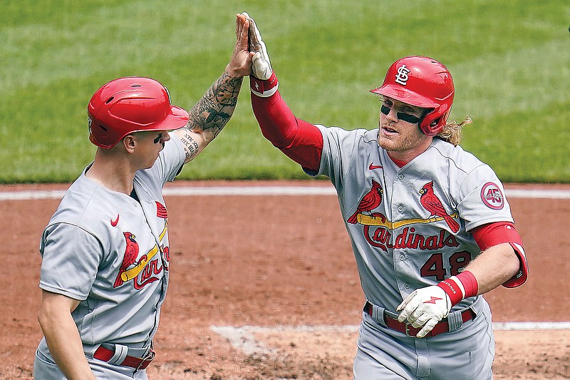 Harrison Bader (right) celebrates with Cardinals teammate Tyler O'Neill as he returns to the dugout after hitting a three-run home run during the second inning of Sunday's game against the Pirates in Pittsburgh.