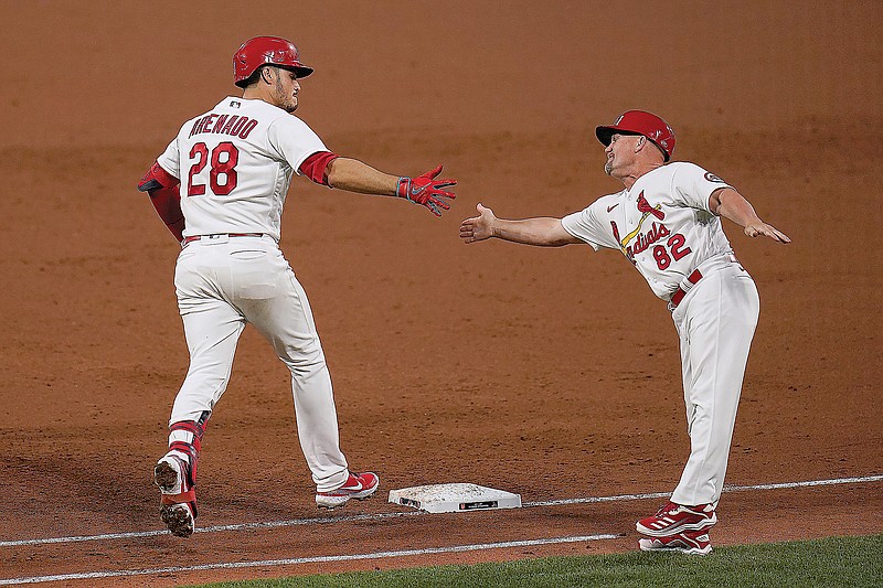 Nolan Arenado is congratulated by Cardinals first base coach Stubby Clapp after hitting a three-run home run during the third inning of Monday night's game against the Mets at Busch Stadium.