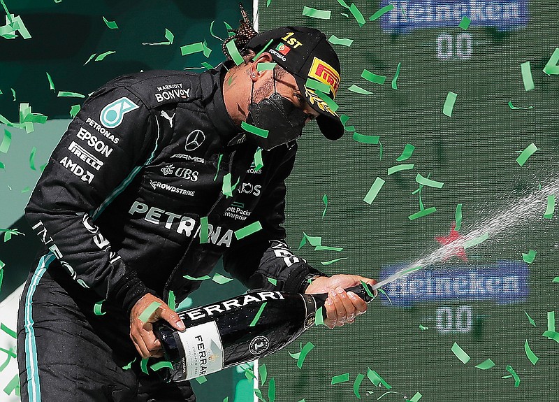 Lewis Hamilton celebrates Sunday after winning the Portugal Formula One Grand Prix near Portimao, Portugal.