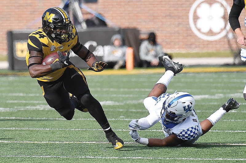 In this Oct. 24, 2020, file photo, Missouri running back Larry Rountree III  eludes the tackle attempt of Kentucky's Davonte Robinson during a game at Faurot Field, Runtree was a sixth-round draft pick of the Chargers.