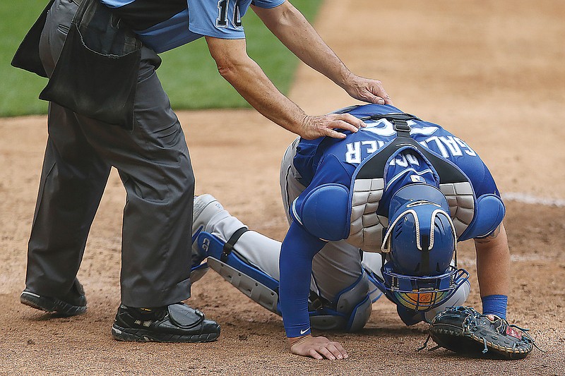Royals catcher Cam Gallagher reacts after getting hit with a foul ball in the eighth inning of Sunday's game against the Twins in Minneapolis.
