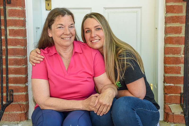 Julie Smith/News Tribune
Christine Schuessler and her daughter, Becky Schuessler, share a  special moment during an interview and photograph session Friday, April 30.