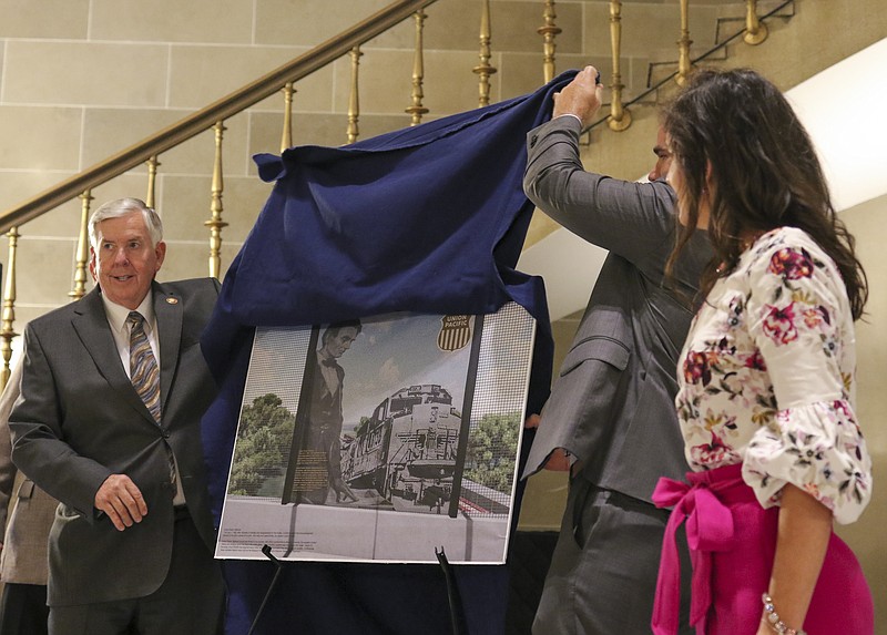 Missouri Gov. Mike Parson and Clint Schelbitzki, Union Pacific Assistant Vice President of Public Affairs, unveil concept art for a designed panel of the Bicentennial Bridge during the Union Pacific bicentennial sponsorship event on Tuesday, May 4, 2021. Union Pacific donated $200,000 toward the project, a 12-foot wide pedestrian walkway extending across the Missouri River.