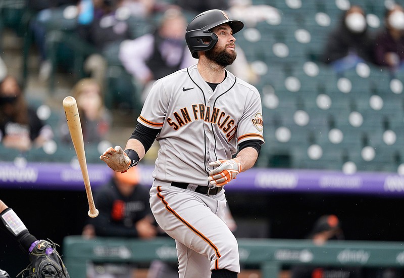 San Francisco Giants' Brandon Belt follows the flight of his three-run home run off Colorado Rockies relief pitcher Jhoulys Chacin in the first inning of game one of a baseball doubleheader Tuesday, May 4, 2021, in Denver. (AP Photo/David Zalubowski)