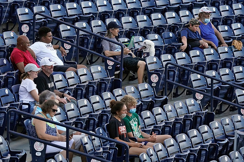 Fans are socially distanced during the first inning of a Low A Southeast League baseball game between the Dunedin Blue Jays and the Tampa Tarpons at George M. Steinbrenner Field Tuesday, May 4, 2021, in Tampa, Fla. Minor league baseball is starting back up after having their season canceled last year by the pandemic. The Tarpons were welcoming dogs at the game. (AP Photo/Chris O'Meara)