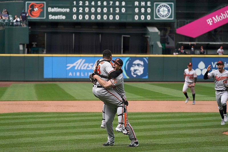 Baltimore Orioles starting pitcher John Means, right, hugs catcher Pedro Severino after Means threw a no-hitter in the team's baseball game against the Seattle Mariners, Wednesday, May 5, 2021, in Seattle. The Orioles won 6-0. (AP Photo/Ted S. Warren)