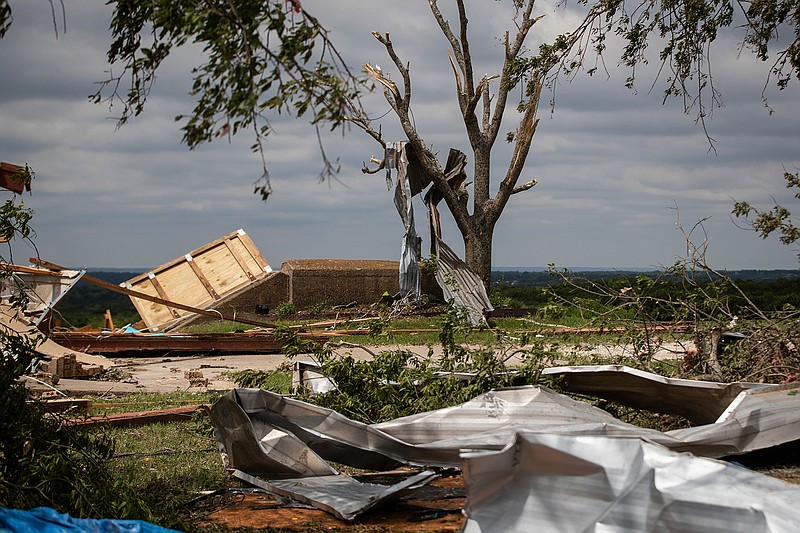 Metal parts of roof are tangled in a tree after a tornado near the storm shelter at the Barn on the Brazos wedding venue Tuesday, May 4, 2021, in Blum, Texas. Curtis Haley took shelter there as the storm hit Monday evening. (Yffy Yossifor/Star-Telegram via AP)