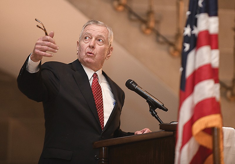 Former Missouri Governor and U.S. Attorney General John Ashcroft refers to an inscription on the wall as he delivers the keynote address at Thursday's National Day of Prayer Service in the Capitol Rotunda.