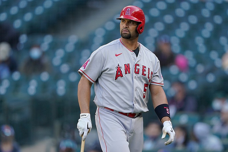 Los Angeles Angels Albert Pujols walks to the dugout after he was called out on strikes during the ninth inning of a baseball game against the Seattle Mariners, Sunday, May 2, 2021, in Seattle.  (AP Photo/Ted S. Warren)