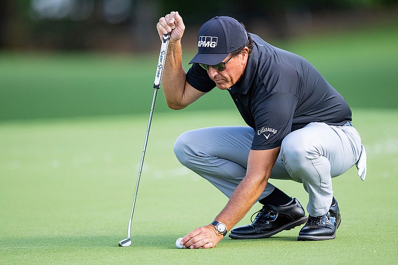 Phil Mickelson lines up his putt on the ninth hole during the first round of the Wells Fargo Championship golf tournament at Quail Hollow Club on Thursday, May 6, 2021, in Charlotte, N.C. (AP Photo/Jacob Kupferman)