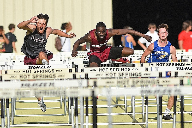 Arkansas High's Jamarious Johnson (center) competes in the boy's 110 meter hurdles during the Arkansas Activities Association 5A-6A track and field meet on Thursday at Hot Springs High School.