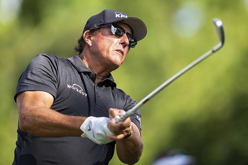 Phil Mickelson watches his tee shot on the sixth hole during Thursday's first round of the Wells Fargo Championship at Quail Hollow in Charlotte, N.C.