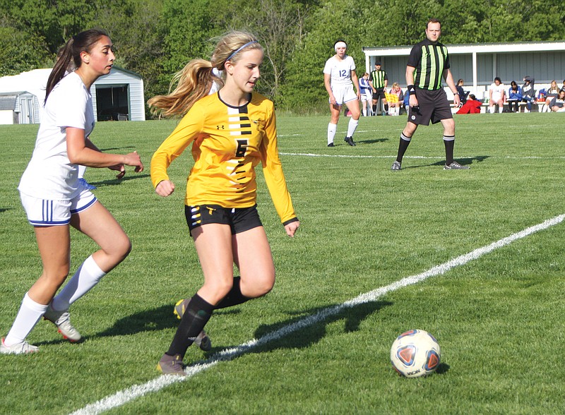 Fulton junior Maddie Dyro dribbles the ball into the Hornets' offensive side of the field during Thursday's game against Moberly at Fulton High School.