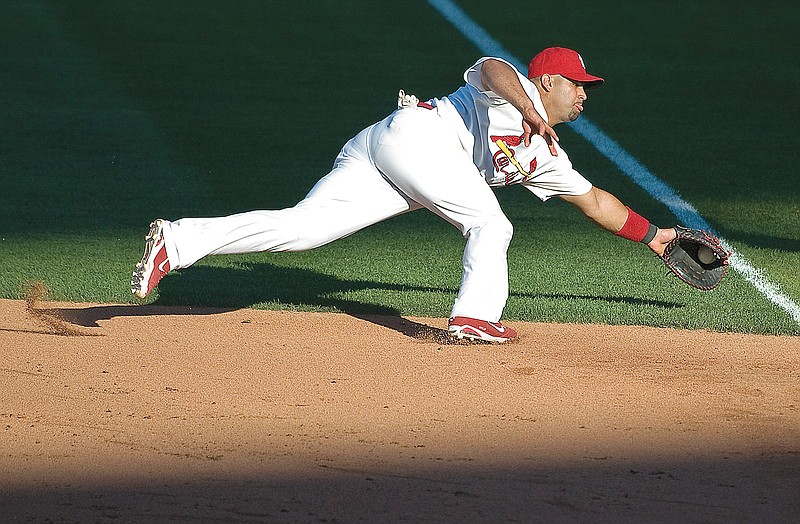 In this Aug. 27, 2011, file photo, Cardinals first baseman Albert Pujols dives for a ball hit by Ryan Doumit of the Pirates during a game at Busch Stadium.