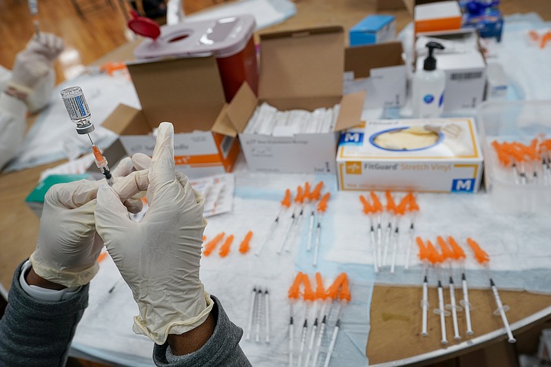 FILE - In this April 8, 2021, file photo, a Northwell Health registered nurses fills a syringe with the Johnson & Johnson COVID-19 vaccine at a pop up vaccination site at the Albanian Islamic Cultural Center in the Staten Island borough of New York. The Biden administration on Wednesday, May 5,  joined calls for more sharing of the technology behind COVID-19 vaccines to help speed the end of the pandemic, a shift that puts the U.S. alongside many in the developing world who want rich countries to do more to get doses to the needy. (AP Photo/Mary Altaffer, File)