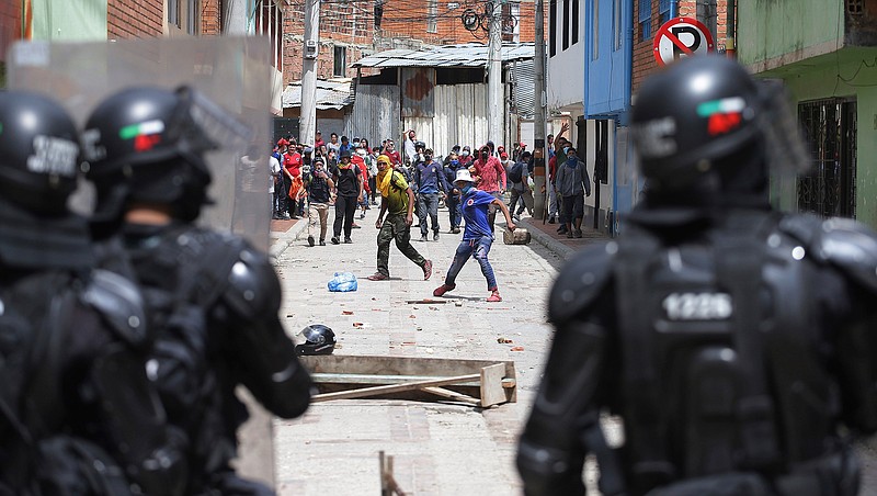 Anti-government protesters clash with police in Gachancipa, Colombia, Friday, May 7, 2021. The protests that began last week over a tax reform proposal continue despite President Ivan Duque's withdrawal of the tax plan on Sunday, May 2. (AP Photo/Ivan Valencia)