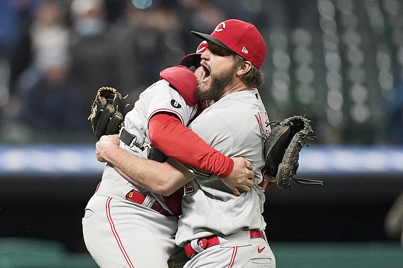 Reds starting pitcher Wade Miley (right) is congratulated by catcher Tucker Barnhart after pitching a no-hitter Friday night against the Indians in Cleveland. 