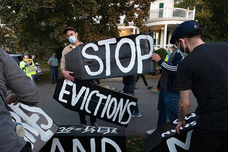  In this Oct. 14, 2020, file photo, housing activists erect a sign in front of Massachusetts Gov. Charlie Baker's house in Swampscott, Mass. A federal judge has ruled, Wednesday, May 5, 2021, that the Centers for Disease Control exceeded its authority when it imposed a federal eviction moratorium to provide protection for renters out of concern that having families lose their homes and move into shelters or share crowded conditions with relatives or friends during the pandemic would further spread the highly contagious virus. (AP Photo/Michael Dwyer, File)