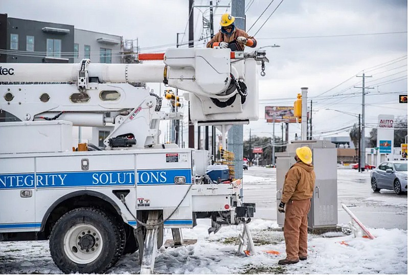 Electrical workers repair a power line Feb. 18 in Austin. Some of the state's electricity providers are financially underwater in the aftermath of the February power outages. (Sergio Flores for The Texas Tribune)
