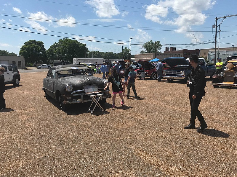 Children chalk up words, letters and statements on a late 1940s automobile Saturday at the Spring Antique Automobile Show hosted by Four States Auto Museum in downtown Texarkana. The museum will host a fall antique show on Oct. 30.