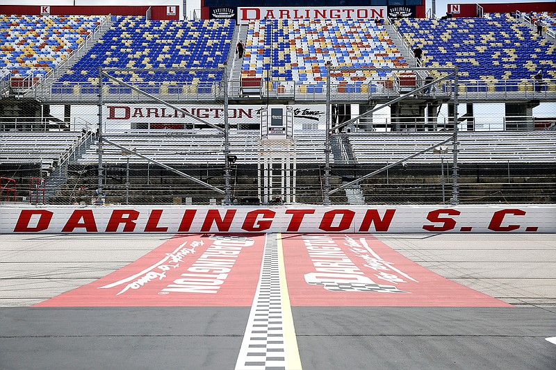 In this May 17, 2020, file photo, the grandstands are empty at Darlington Raceway before a NASCAR Cup Series auto race in Darlington, S.C. Darlington Raceway officials are excited about hosting the first of two scheduled NASCAR weekends, something the track hadn't featured since 2004. (AP Photo/Brynn Anderson, File)