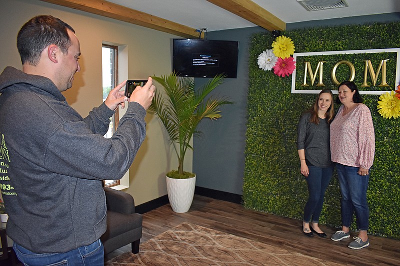 Gerry Tritz/News Tribune
Matthew Pope, left, takes a Mother's Day photograph of wife, Tara, and her mother, Lisa, before the 8 a.m. Mother's Day-themed service at Solid Rock Family Church Sunday.