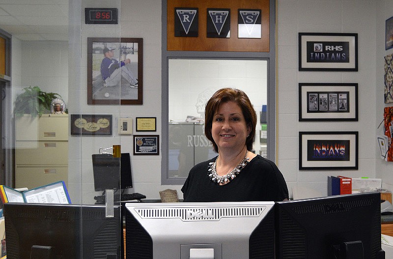 In this September 2015 file photo, Judy Wilson sits at her desk as administrative assistant at Cole R-1 High School in Russellville, Mo.