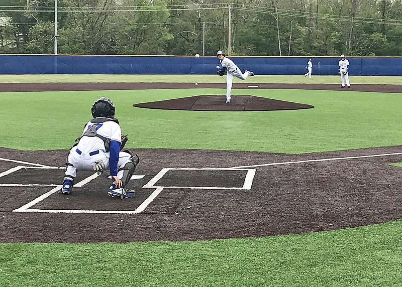 Capital City pitcher Taggert Bodenstab throws a warmup pitch to catcher Brock Miles before Tuesday's game against Cuba at Capital City High School.