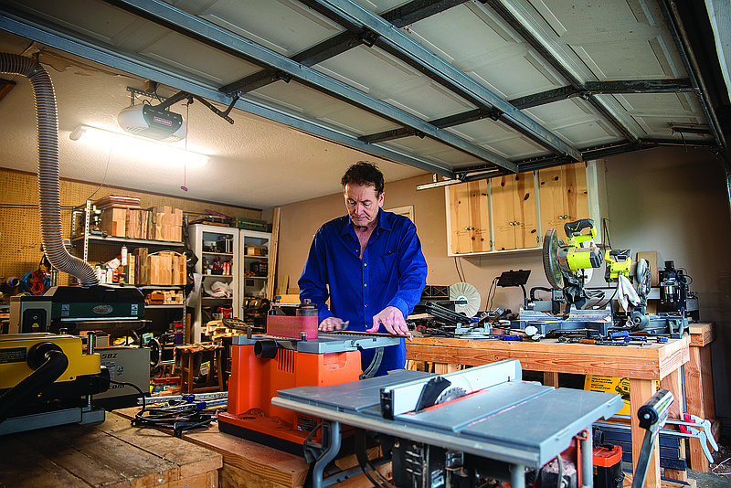 Bryan Jefferies, owner of B-Custom Guitars, shown in his home workshop, started his business after having downtime during the pandemic, and has since sold at least seven custom-built guitars.