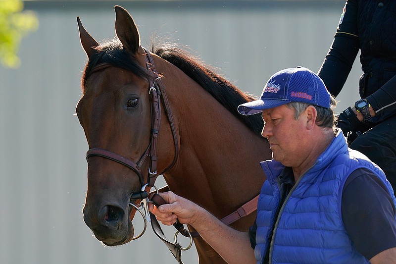 Preakness hopeful Concert Tour is walked to the track for a morning exercise at Pimlico Race Course ahead of the Preakness Stakes horse race, Tuesday, May 11, 2021, in Baltimore. (AP Photo/Julio Cortez)