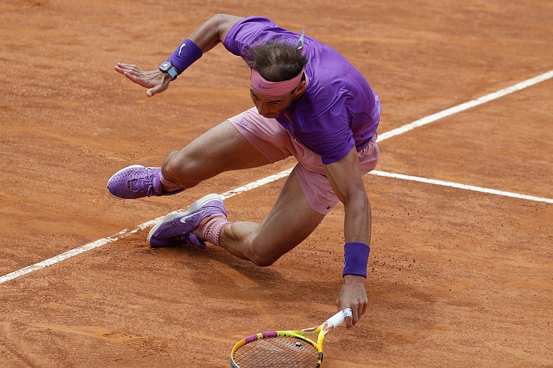 Spain's Rafael Nadal falls on the court as he attempts to return the ball to Germany's Alexander Zverev during their quarter-final match at the Italian Open tennis tournament, in Rome, Friday, May 14, 2021. (AP Photo/Gregorio Borgia)