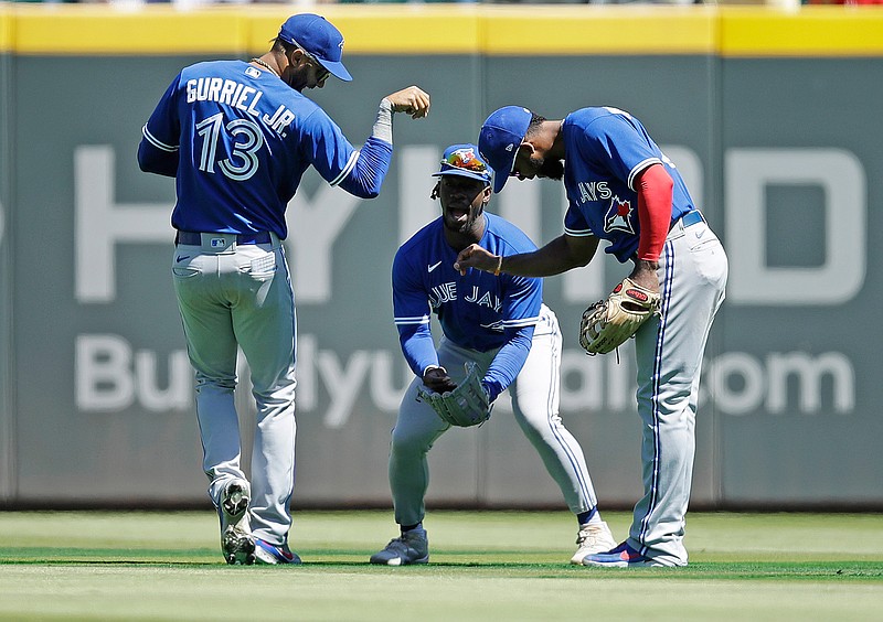 Toronto Blue Jays' Lourdes Gurriel Jr. (13) celebrates in the outfield at the end of a baseball game against the Atlanta Braves Thursday, May 13, 2021, in Atlanta. (AP Photo/Ben Margot)