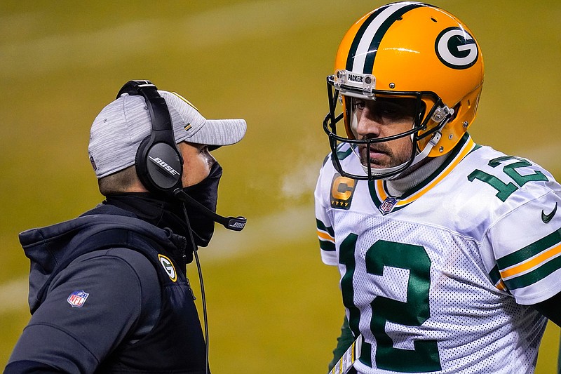 FILE - In this Jan. 3, 2021, file photo, Green Bay Packers head coach Matt LaFleur, left, talks to Aaron Rodgers during the second half of an NFL football game against the Chicago Bears in Chicago. LaFleur reiterated his hope that he'd get to continue working with Rodgers this season while offering no news on the quarterback's status. (AP Photo/Charles Rex Arbogast, File)