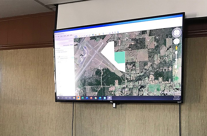 Local airport board members reviewed an aerial view of where land they want to buy sits relative to a runway during a presentation Friday in Texarkana, Ark. Staff photo by Greg Bischof