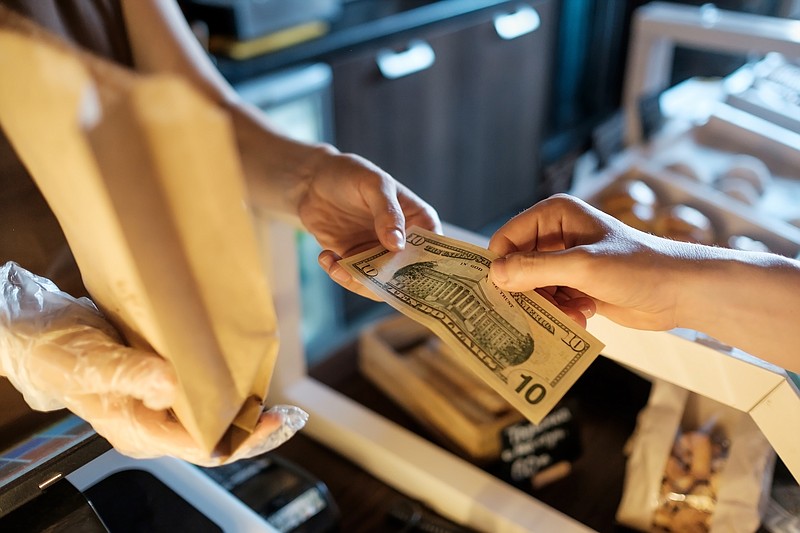 Some state and city leaders want to require retailers to accept cash. (Dreamstime/TNS)
