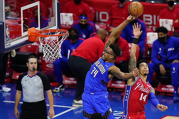 Orlando Magic's Wendell Carter Jr., left, tries to get a shot past Philadelphia 76ers' Danny Green during the first half of an NBA basketball game, Friday, May 14, 2021, in Philadelphia. (AP Photo/Matt Slocum)