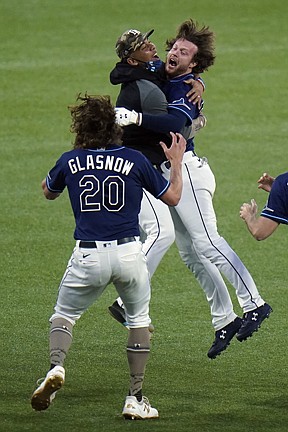 Tampa Bay Rays' Brett Phillips, right, celebrtes with teammates, including Tyler Glasnow after his walk-off RBI single off New York Mets relief pitcher Aaron Loup scored Brandon Lowe during the ninth inning of a baseball game Friday, May 14, 2021, in St. Petersburg, Fla. (AP Photo/Chris O'Meara)